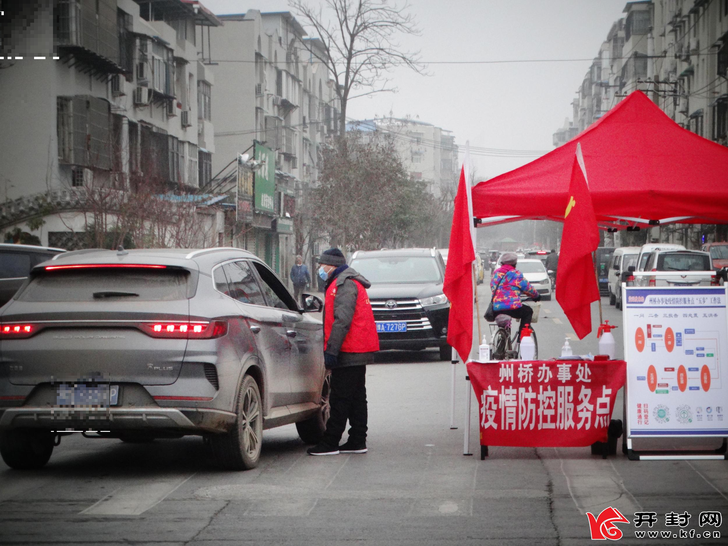 1月12日，包南社区西坡西街疫情防控卡点，志愿者冒着严寒坚守岗位，查验进入人员双码和测量体温，守护好群众身体健康和生命安全。全媒体记者 李俊生 摄