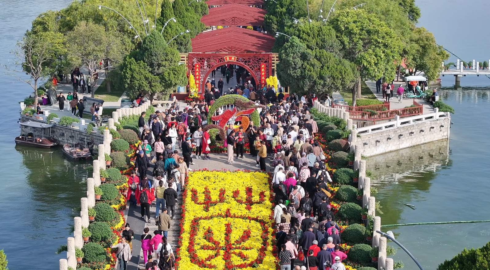 在龙亭景区，各式各样的菊艺造型和精彩纷呈的演出，吸引众多市民和游客。全媒体记者 袁洋 摄